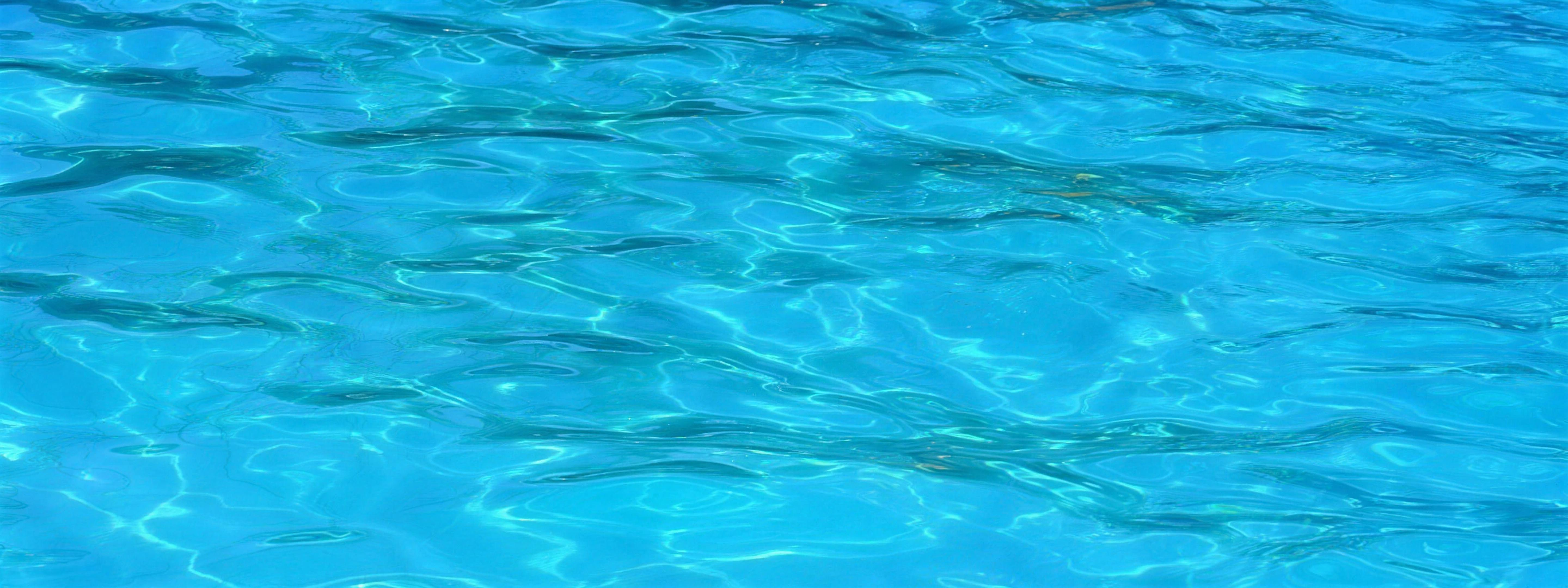 Eau turquoise d'une piscine Arrodel, caustics solaires